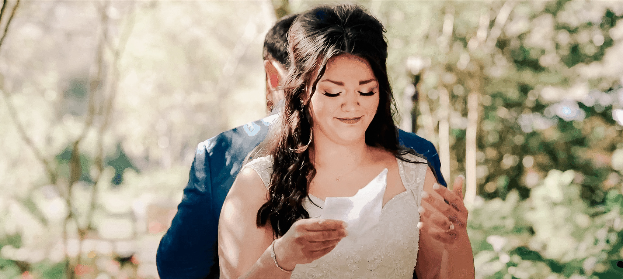 Emotional bride privately reading vows to her groom during a first touch moment