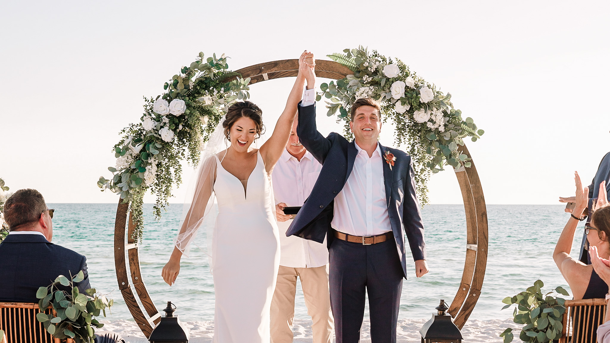 Bride and groom celebrate for their 30A destination beach wedding video at their ceremony in Panama City Beach, Florida.