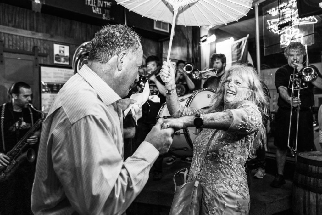 Couple dances in O'Daly's Bar while the Mobile Secondline Society brass band plays in the background for their Mobile, AL wedding video