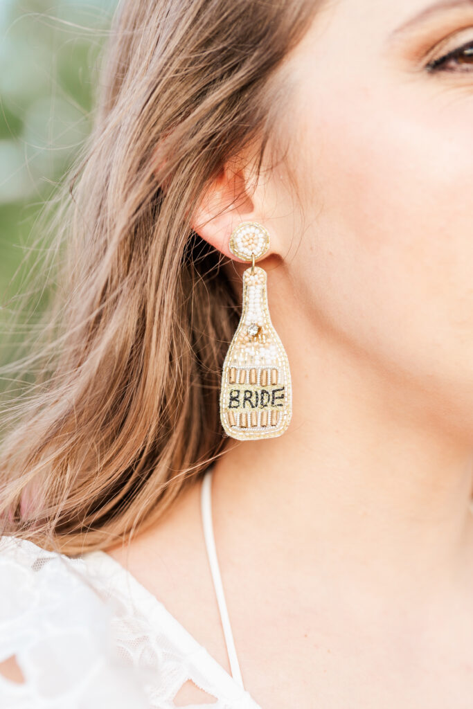 Champagne bead earrings with the word "BRIDE" on them