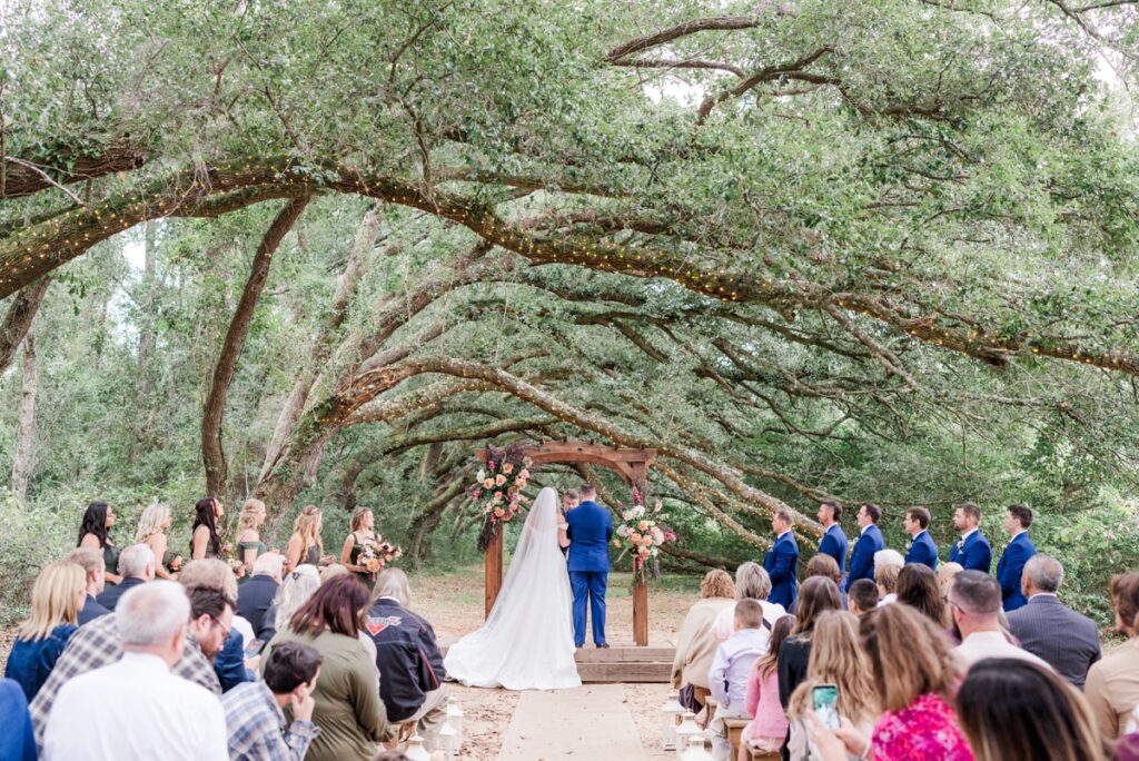 Fall Fairhope wedding ceremony at Oak Hollow Farm that featues a tunnel of oak trees